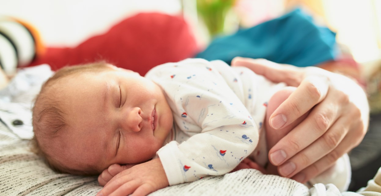 Novorojencek spi v ocetovem narocju